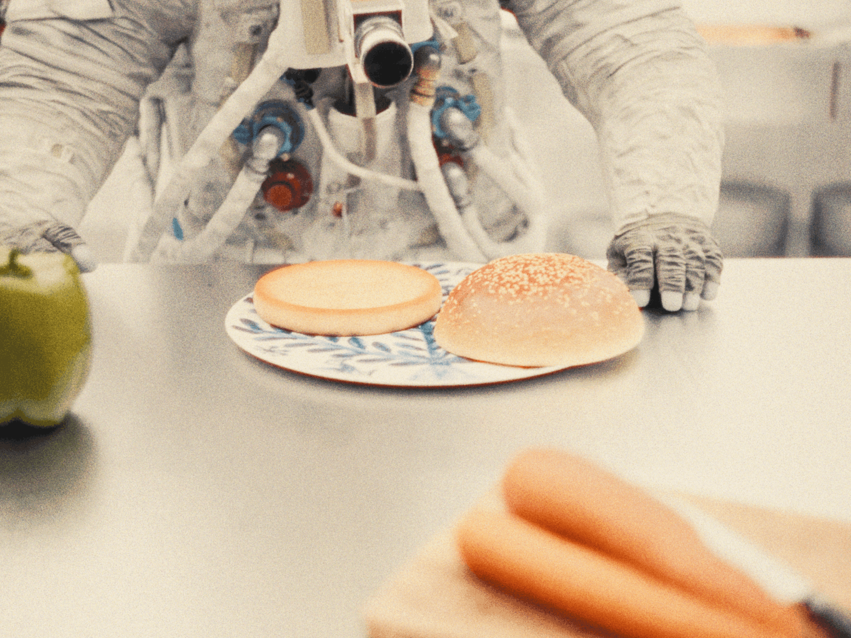 Miss A7L leaning on a table with a burger bun on a plate.
